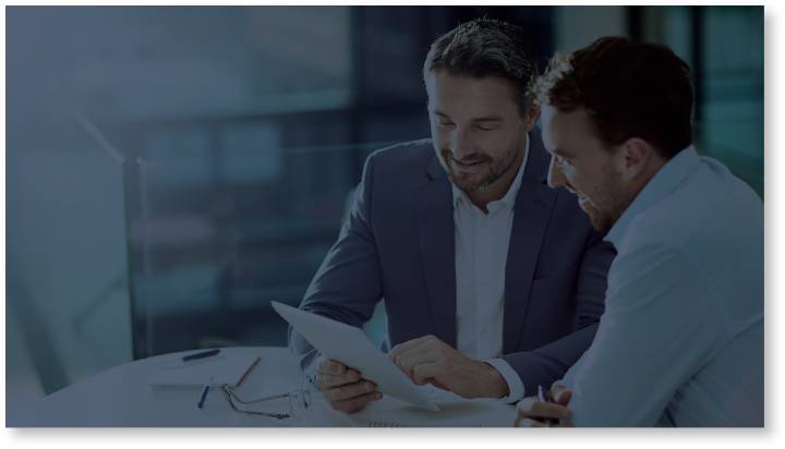 Two Businessmen Discussing a Project in an Office